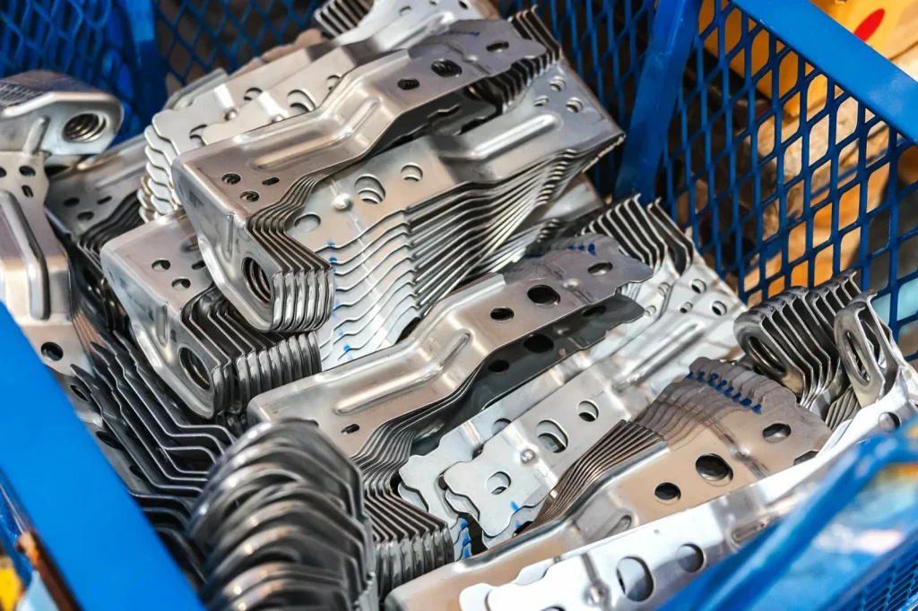 Bedna s přesnými kovovými díly zdůrazňuje sílu CNC obrábění ve velkosériové výrobě oproti 3D tisku.