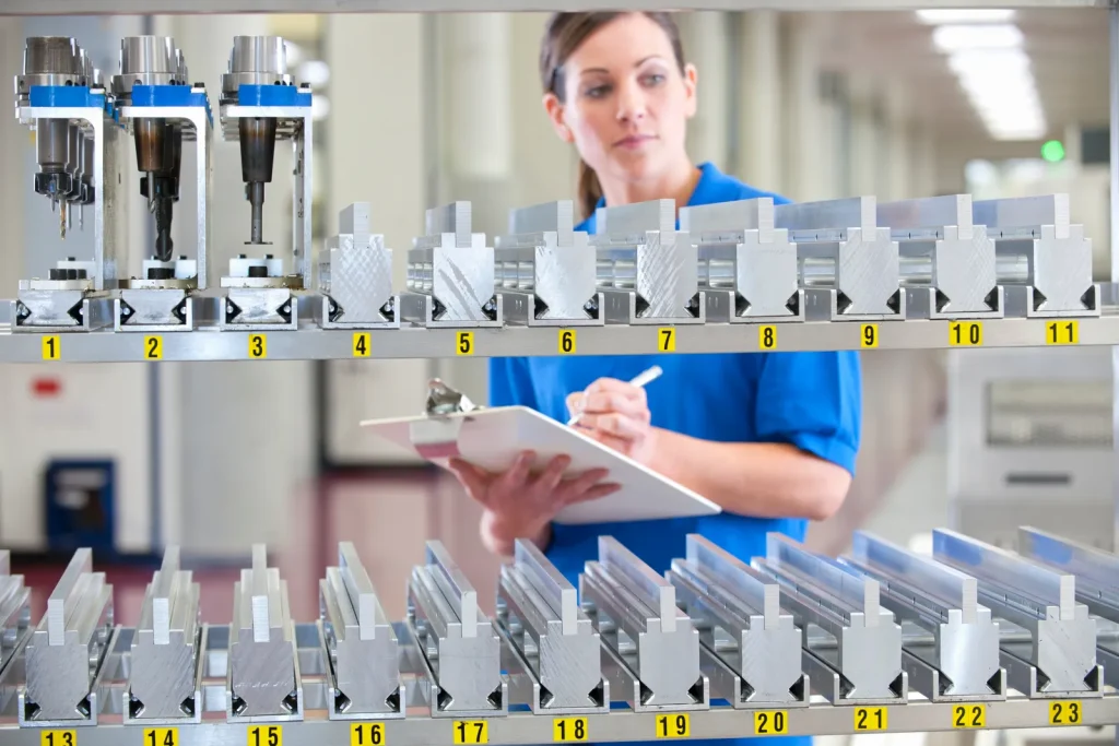 A quality inspector verifies custom CNC parts in a Chinese factory.