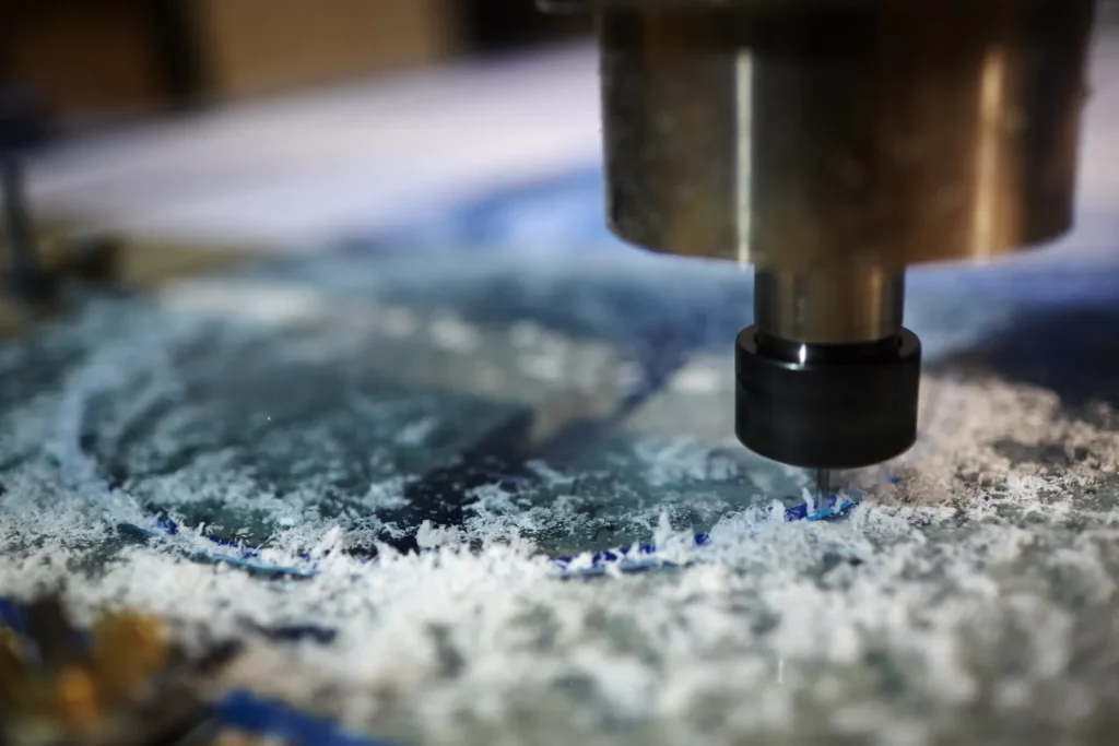 A CNC cutting tool precisely machines a workpiece, producing fine material chips.