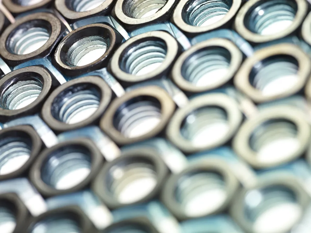 A close-up view shows precision threaded components made via CNC milling.