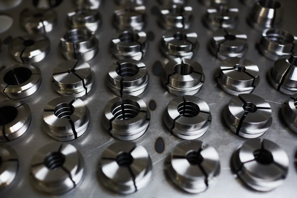 Finished precision metal parts, produced by CNC milling, are neatly arranged.