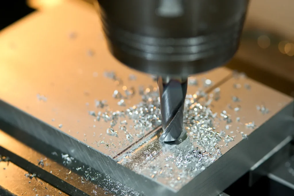 Une fraise CNC usine de l'aluminium, produisant de fins copeaux métalliques.