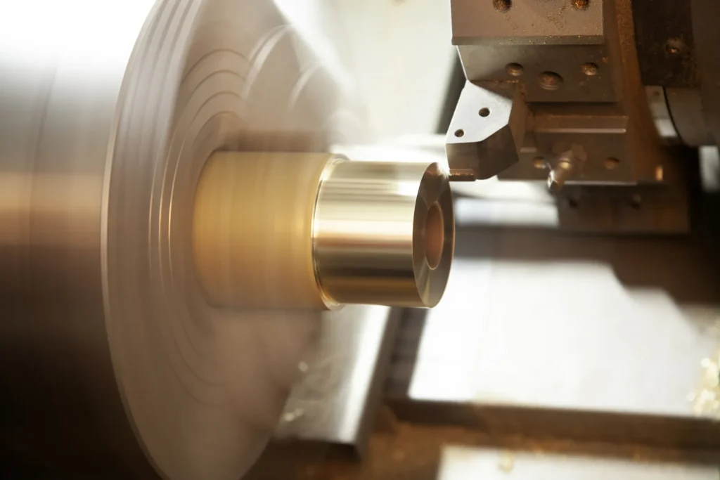 Lathe machining a copper cylinder, demonstrating high-precision custom turning operations.